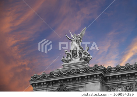 Golden statue of Liberty on the roof of the Opera Garnier (Garnier Palace) against the sky at sunset. Sculpted by Charles Gumery in 1869. Paris, France. UNESCO World Heritage Site Golden statue of Liberty on the roof of the Opera Garnier (Garnier Palace) against the sky at sunset. Sculpted by Charles Gumery in 1869. Paris, France. UNESCO World Heritage Site 109094389