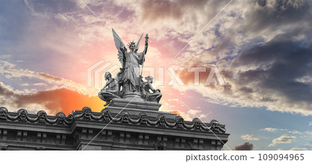 Golden statue of Liberty on the roof of the Opera Garnier (Garnier Palace)  against the sky at sunset. Sculpted by Charles Gumery in 1869. Paris, France. UNESCO World Heritage Site 109094965