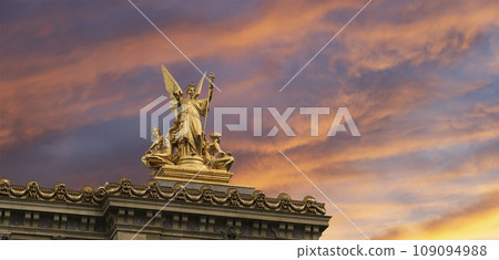 Golden statue of Liberty on the roof of the Opera Garnier (Garnier Palace)  against the sky at sunset. Sculpted by Charles Gumery in 1869. Paris, France. UNESCO World Heritage Site 109094988