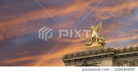 Golden statue of Liberty on the roof of the Opera Garnier (Garnier Palace)  against the sky at sunset. Sculpted by Charles Gumery in 1869. Paris, France. UNESCO World Heritage Site 109094990