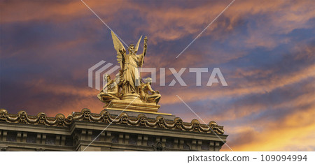Golden statue of Liberty on the roof of the Opera Garnier (Garnier Palace)  against the sky at sunset. Sculpted by Charles Gumery in 1869. Paris, France. UNESCO World Heritage Site 109094994