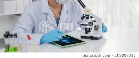 Laboratory researcher develop new medicine or cure using microscope. Rigid Laboratory researcher develop new medicine or cure using microscope. Rigid 109097315