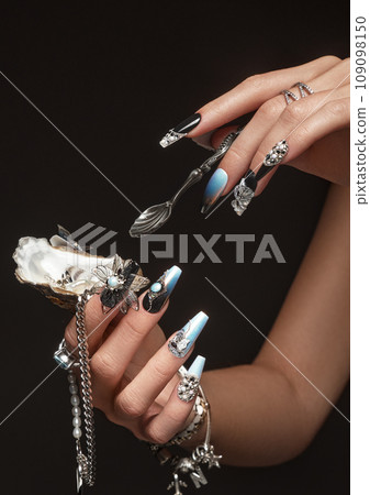 Creative design of nails on female hands. Art manicure. Creative design of nails on female hands. Art manicure. 109098150