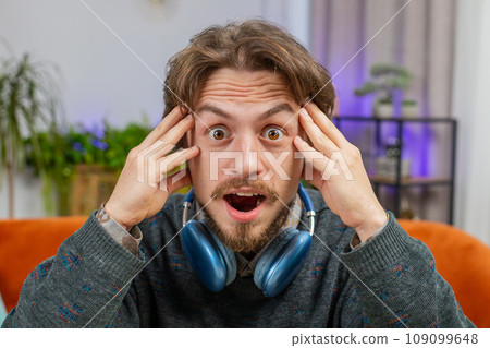 Excited Caucasian man surprised, shocked by sudden victory, good win news, celebrating, wow reaction 109099648