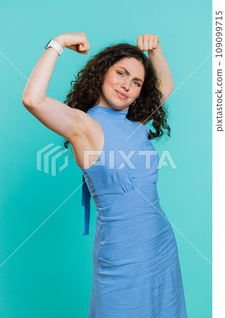 Woman showing biceps and looking confident, feeling power strength to fight for rights, success win 109099715