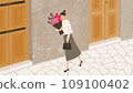 A woman walking along the cobblestones with a bouquet of flowers 109100402