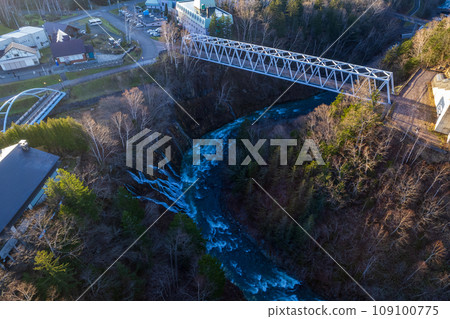Drone photography | Aerial view of Shirahige Falls flowing into many strings | Biei River | Shirokane, Biei-cho, Hokkaido 109100775