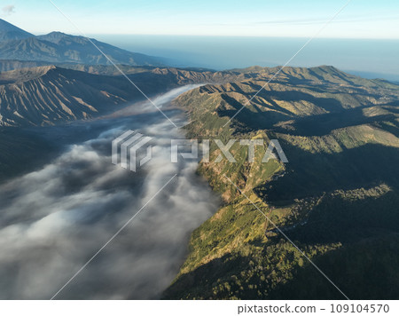 Aerial view Mountains at Bromo volcano during sunrise sky,Beautiful Mountains Penanjakan in Bromo Tengger Semeru National Park,East Java,Indonesia.Nature landscape background Aerial view Mountains at Bromo volcano during sunrise sky,Beautiful Mountains Penanjakan in Bromo Tengger Semeru National Park,East Java,Indonesia.Nature landscape background 109104570