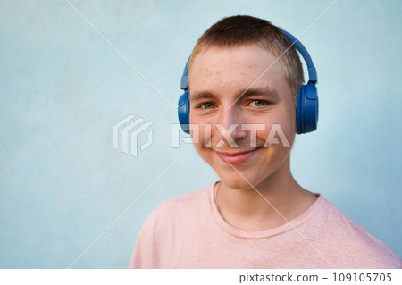 Portrait of a young guy with headphones. Teenage skin problems, acne. lifestyle concept Portrait of a young guy with headphones. Teenage skin problems, acne. lifestyle concept 109105705