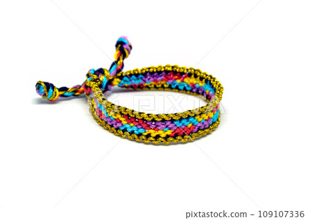 DIY woven tied friendship bracelet with unusual braiding. Summer accessory DIY woven tied friendship bracelet with unusual braiding. Summer accessory 109107336