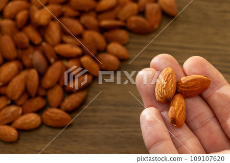 pick up an almond pick up an almond 109107620