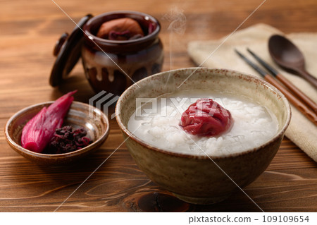 Porridge with pickled plums (ume gayu) served with pickled ginger 109109654