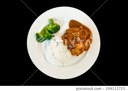 Top view of chicken steak and rice on black background. 109111723