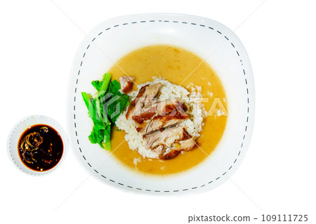 Top view of Roasted duck topping on thai rice with gravy sauce on white background. 109111725