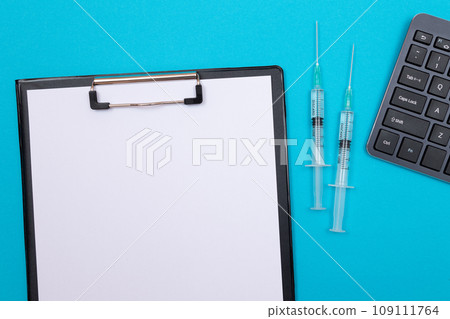 Vaccination or Revaccination Concept - Two Medical Syringe on Blue Table 109111764