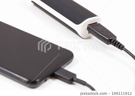 Smartphone with connected plug of powerbank. Telephone charging Smartphone with connected plug of powerbank. Telephone charging 109111912
