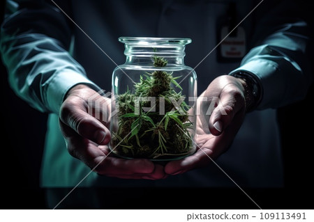 The laboratory doctor holds a glass jar of marijuana in his hands. The laboratory doctor holds a glass jar of marijuana in his hands. 109113491