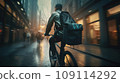 Focused young male delivery man in protective helmet riding bicycle with cardboard boxes on street in city 109114292