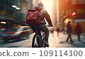 Focused young male delivery man in protective helmet riding bicycle with cardboard boxes on street in city 109114300