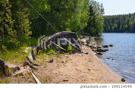 The remains of an old wooden boat on the shore of Valaam Island 109114549