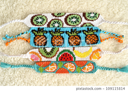 DIY woven friendship bracelets with different braiding. Summer accessory 109115814