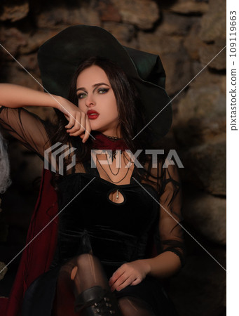 A portrait of a young sexy witch with outside. Magic, dark force, spell. Witchcraft. Halloween. 109119663