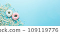 Delicious donuts and delicate white bouquet of flowers on light blue background. Top view, banner 109119776
