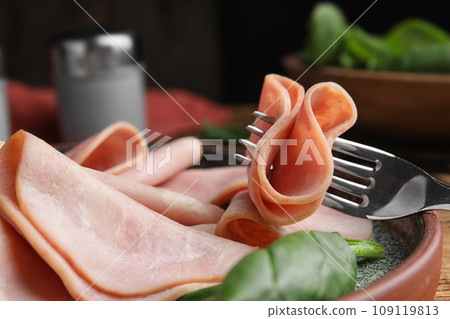 Tasty ham with spinach on table, closeup 109119813