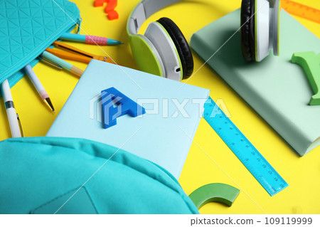Books, headphones and school stationery on yellow background Books, headphones and school stationery on yellow background 109119999