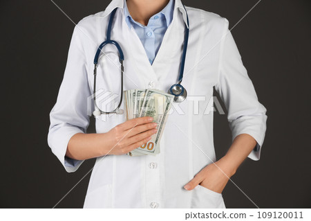 Doctor with bribe on black background, closeup. Corruption in medicine Doctor with bribe on black background, closeup. Corruption in medicine 109120011