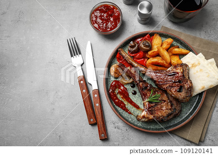 Delicious grilled ribs served on light grey table, flat lay Delicious grilled ribs served on light grey table, flat lay 109120141