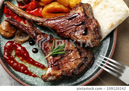 Delicious grilled ribs served on table, flat lay Delicious grilled ribs served on table, flat lay 109120142