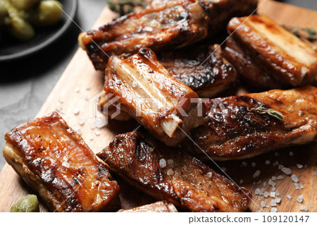 Delicious grilled ribs served on table, closeup Delicious grilled ribs served on table, closeup 109120147