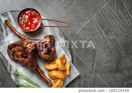 Delicious grilled ribs served on grey table, top view. Space for text Delicious grilled ribs served on grey table, top view. Space for text 109120149