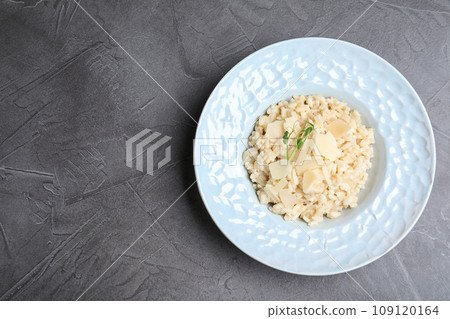 Delicious risotto with cheese on grey table, top view. Space for text Delicious risotto with cheese on grey table, top view. Space for text 109120164