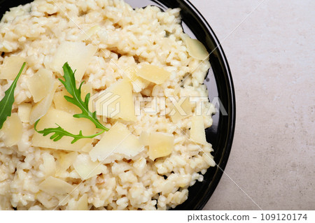 Delicious risotto with cheese on grey table, top view 109120174