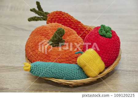 Cute knitted vegetables toys on a wicker plate 109120225