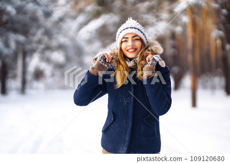 Portrait of young beautiful girl with long hair, in a blue jacket. Fashion woman in winter forest. 109120680