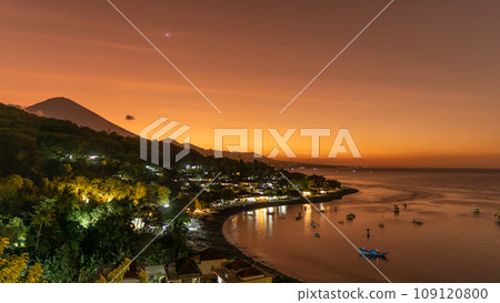 Sunset on the island of Bali with Amed beach and Mount Agung in the background. Indonesia Sunset on the island of Bali with Amed beach and Mount Agung in the background. Indonesia 109120800