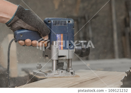 Hand male worker industry grinder tool woodworking board industrial plank equipment close-up Hand male worker industry grinder tool woodworking board industrial plank equipment close-up 109121232