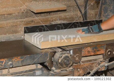 Male Production Workshop Worker Hand Grinding Wooden Board On Machine Tool Industrial Equipment Male Production Workshop Worker Hand Grinding Wooden Board On Machine Tool Industrial Equipment 109121302
