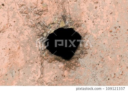 Hole circle round in concrete color old dirty wall, isolated black, close-up Hole circle round in concrete color old dirty wall, isolated black, close-up 109121337