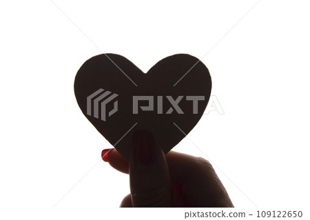 Symbol of heart and love in female hand - silhouette, isolated 109122650