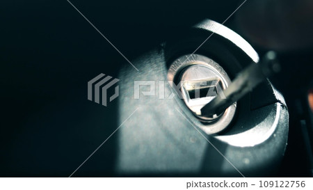 Inserting car key into the lock and starting the engine, close-up Inserting car key into the lock and starting the engine, close-up 109122756