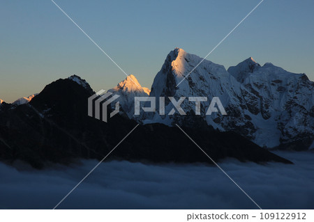 Sun lit mountains Ama Dablam and Cholatse at sunset, Nepal. 109122912