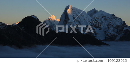 Sun lit peak of Mount Ama Dablam and Cholatse at sunset, Nepal. 109122913