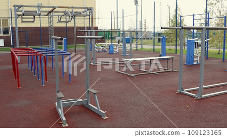 outdoor metal exercise equipment on a sports ground without people, a sports lifestyle in an urban space, equipment for street strength training, sports in an urban environment outdoor metal exercise equipment on a sports ground without people, a sports lifestyle in an urban space, equipment for street strength training, sports in an urban environment 109123165