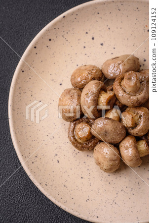 Delicious juicy whole champignons baked on the grill with salt and spices 109124152