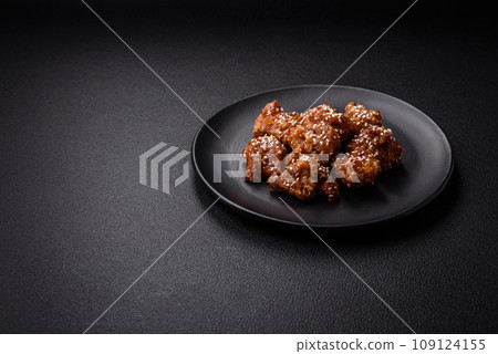 Delicious Asian dish with pieces of chicken in teriyaki sauce with salt and spices 109124155