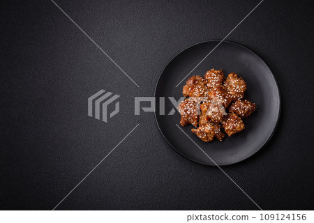 Delicious Asian dish with pieces of chicken in teriyaki sauce with salt and spices Delicious Asian dish with pieces of chicken in teriyaki sauce with salt and spices 109124156